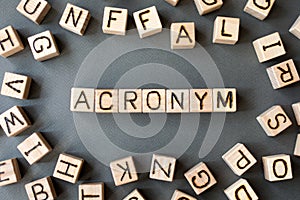 The word acronym wooden cubes with burnt letters