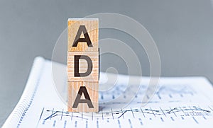 Word ADA Americans with Disabilities Act is made of wooden blocks, grey background