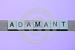word adamant made from wooden gray letters photo