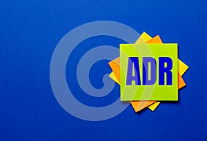 The word ADR Alternative Dispute Resolution is written on bright stickers on a blue background