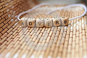 Word adverb lined with wooden cubes photo