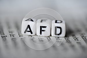 Word AFD formed by wood alphabet blocks on newspaper german party politics