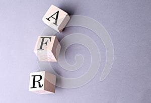 Word AFR on wooden block on the grey background photo