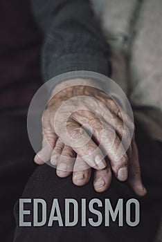 Word ageism in spanish and old couple hold hands