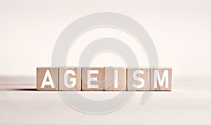 The word ageism on wooden blocks against white background. Age discrimination in business