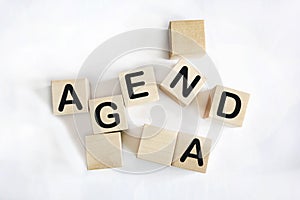 The word AGENDA. Wooden cubes with letters isolated on white background