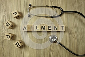 Word ailment from wooden blocks with stethoscope photo