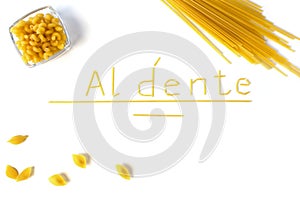 Word `al dente` with spaghetty, shells and macaroni in bowl photo