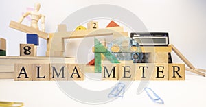 The word Alma meter was created from wooden cubes. Close-up.