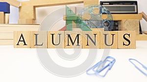 The word Alumnus was created from wooden cubes. photo