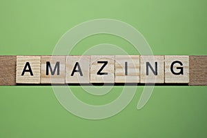 word amazing made of small gray wooden letters