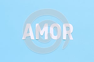 Word AMOR on a light blue background