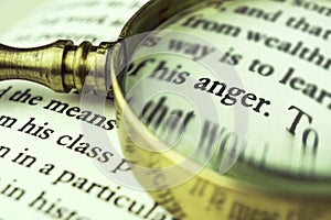 The word `anger` emphasized by a magnifying glass.