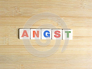 Word Angst on wood background