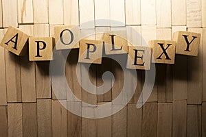The word Apoplexy was created from wooden cubes. Health and life Close up. photo