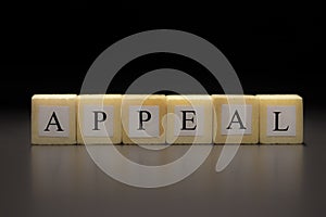 The word APPEAL written on wooden cubes isolated on a black background