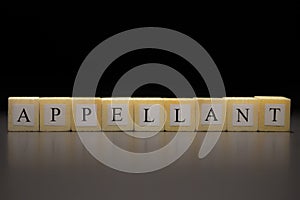 The word APPELLANT written on wooden cubes isolated on a black background photo