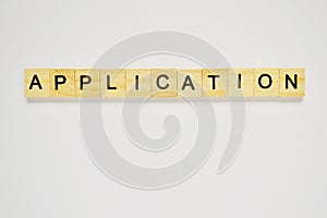 Word application. Top view of wooden blocks with letters on white surface