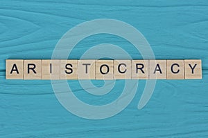 word aristocracy made from wooden gray letters photo