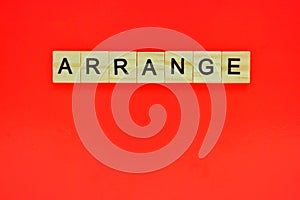 Word arrange. Top view of wooden blocks with letters on red surface