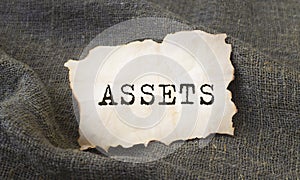 Word Assets on craft paper on linen cloth. Financial accounting. Money concept
