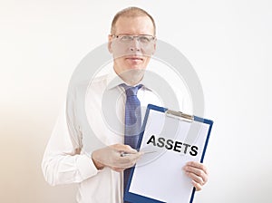 Word Assets on paper in businessman hand Financial accounting. Money concept