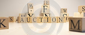 The word aution is from wooden cubes. Background from wooden letters. Close up