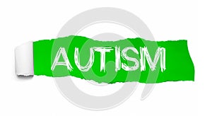 The word AUTISM appearing behind green torn paper