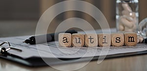 Word AUTISM composed of wooden dices photo