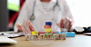 Word autism is written on background of doctor in clinic closeup 4k movie slow motion