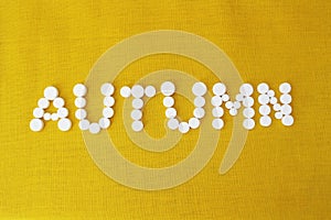 The word `autumn` has white