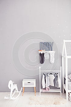 The word baby on a gray background. Inscription toddler. Detail of the interior of the children`s room. Children bedroom