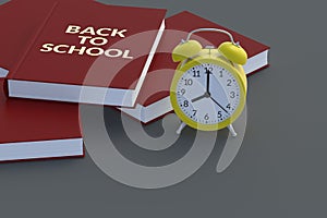 Word back to school on book near alarm clock. Education concept. Copy space