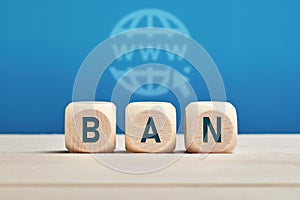 The word ban on wooden cubes with internet www icon background. Internet ban and censorship