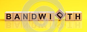 Word Bandwidth is made of wooden building blocks lying on the table and on a light yellow background