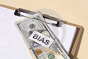 the word Bias and and 100 dollar bills. Prejudice. Personal opinions