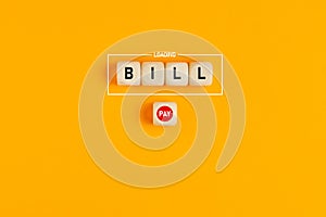 The word bill loading written on wood blocks with a push payment button. Concept of online bill payment in business or finance