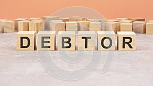 word blocks lined up with the letters DEBTOR written on it. copy space available