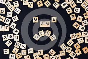 Word BOARD GAME with wooden letters on black board and letter in