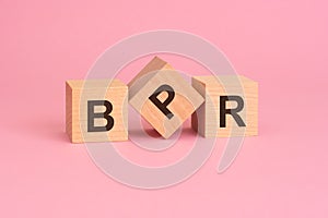 the word BPR - Business Process Reengineering, on wooden cubes, on a pink background