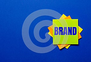 The word BRAND is written on bright stickers on a blue background