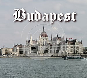 The word Budapest in old font with the Hungarian Parliament in the background