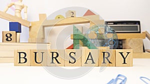 The word Bursary was created from wooden cubes. close up