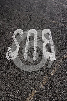 The word BUS painted on the asphalted gray floor