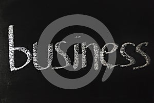 The word business written in white chalk on a black chalkboard