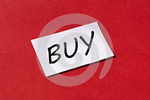 Word buy on a red background. Shopping concept