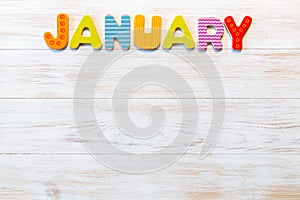 Word of calendar with month January on wood background