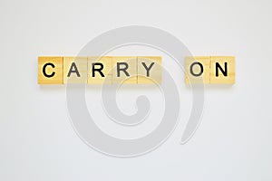 Word carry on. Top view of wooden blocks with letters on white surface