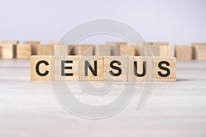 word CENSUS inscribed on wooden cubes lying on a light table. economy and investments concept.