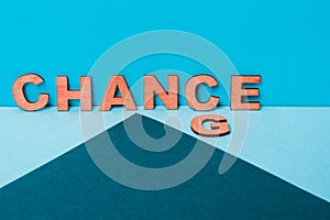Word Change to Chance from wooden letters on a blue background